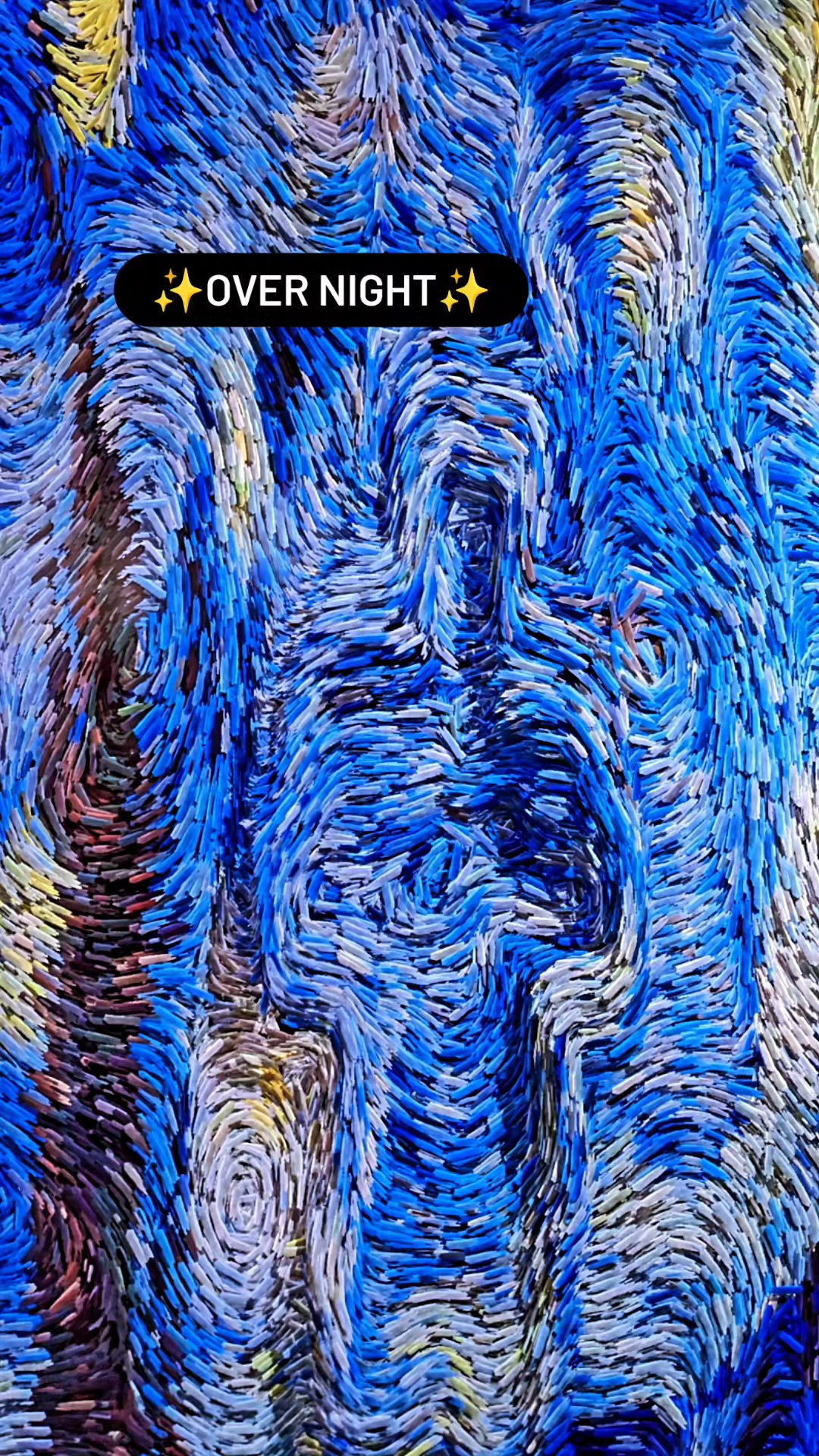 Blue and gold generative particle artwork documented in an exhibition